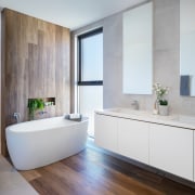 This bathroom continues the use of natural materials architecture, bathroom, bathroom accessory, bathroom cabinet, bathtub, beige, building, cabinetry, ceiling, ceramic, floor, flooring, furniture, hardwood, home, house, interior design, material property, plumbing fixture, property, real estate, room, sink, tap, tile, wall, wood flooring, gray