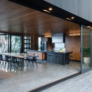 ​​​​​​​Context is everything. This kitchen connects with and architecture, backyard, building, ceiling, deck, design, estate, floor, flooring, furniture, home, house, interior design, landscaping, patio, porch, property, real estate, roof, room, table, gray, black