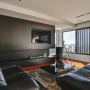 ​​​​​​​Dark living room cabinetry anchors the white, open gray, black