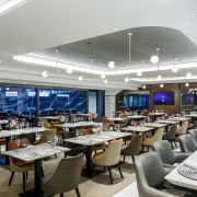 Stadia are looking at ways to monetise beyond architecture, building, business, cafeteria, ceiling, interior design, restaurant, room, table, gray, white