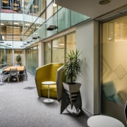 The existing glass lifts and stairs pass through architecture, building, floor, furniture, interior design, atrium, office, property, Treasury Offices, Precinct Properties, Workspace Architects