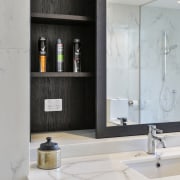 ​​​​​​​Smoked oak vanity joinery connects with wall cabinet 