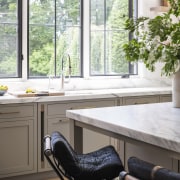 ​​​​​​​Marble countertops add to this Studio Dearborn kitchen’s 