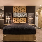 ​​​​​​​This floor-to-ceiling ensuite shower corresponds to the bedhead orange, brown