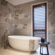 ​​​​​​​Large, distressed-look wall tiles add to the sense 