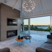 ​​​​​​​Room-high glass sliders open up this lakeside home 