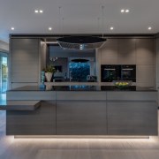 ​​​​​​​The pared-back kitchen cabinetry in this lakeside home 