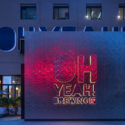 On the exterior, the large font lettering of “Oh advertising, architecture, blue, building, electronic signage, facade, font, light, lighting, neon, night, real estate, signage, technology, blue