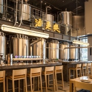 A shining focal point in the dramatic Oh architecture, brewery, building, design, furniture, interior design, room, table, brown, black