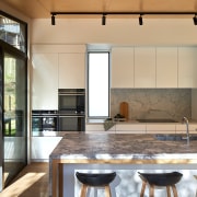Kitchen island's stone benchtop in the sunlight. 