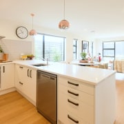 The white cabinetry and light-toned oak veneer floors 