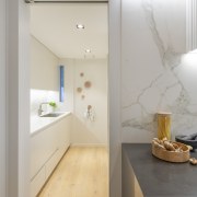 An adjoining bathroom behind the kitchen was reconfigured architecture, beige, building, ceiling, design, floor, flooring, furniture, home, house, interior design, loft, material property, property, real estate, room, tile, wall, gray