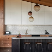 Pendants accentuate the height of the sloping ceiling. 