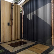 Outdoor shower with baton fence behind. - Ancient 