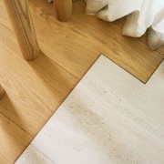 Where the wood bedroom floor meets the tiled 
