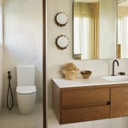 The sculptural wall mirror and wall sconces are 