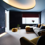 Indirect lighting and dark wall tones set the 