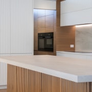 Crenulated cabinet faces on the wall cabinetry are 