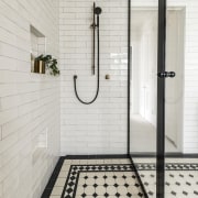 The spacious shower stall includes a slide shower gray