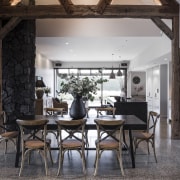 The dining area with rustic beams overhead. 