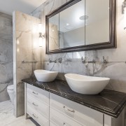 The natural stone vanity top provides a stunning architecture, bathroom, bathroom accessory, bathroom cabinet, building, cabinetry, ceiling, countertop, floor, flooring, furniture, home, house, interior design, marble, material property, plumbing fixture, property, real estate, room, sink, tap, tile, wall, gray