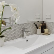 The main bathroom features a pebble mosaic vanity 