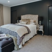 The master bedroom features a black accent wall 