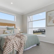 The second upstairs bedroom with built-in display shelving. 