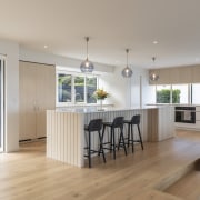 Pale timber floors team with light-wood cabinetry in 