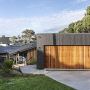 The reinvented home is clad in dark-stained vertical 