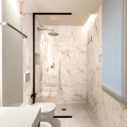 The spa-like bathroom with large format stone tiles. 