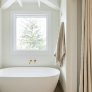 The tub is set below a window that, 