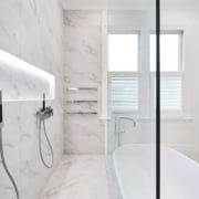 A floor-to-ceiling glass shower wall gives this bathroom bathroom, floor, home, interior design, property, room, tap, tile, white