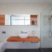 Most design elements are simple and unadorned, and architecture, bathroom, building, floor, furniture, house, interior design, plumbing fixture, property, real estate, room, sink, tile, gray