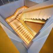 Orange-coloured mirrors underneath the staircase further affirm the 