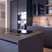 Dark cabinetry finishes are complemented by a generous 