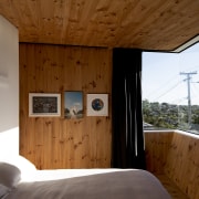 High ceilings and sloping walls of exposed timber brown