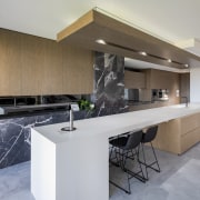 The reworked kitchen features stone and wood cabinetry. 