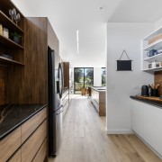 Copper-toned tiles in the scullery connect with the 