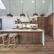 Under a soaring ceiling, the kitchen also picks 