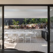 Covered outdoor dining at rear of home. - 