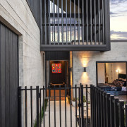 The black steel front gate view with concrete 