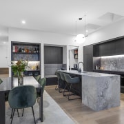 Board-formed concrete to the left and stone-finished island 