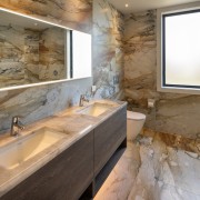 A mirrored cabinet provides discreet storage while further 