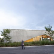 The dynamic concrete façade is cut away, the 