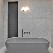 The large format porcelain tiles minimise the need 