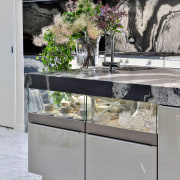 Glass-fronted display storage fronts the kitchen's sizeable island. 