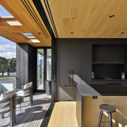 The covered deck includes skylights overhead. 