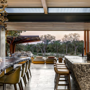 The open, seamless boundaries between interior and exterior architecture, backyard, building, ceiling, deck, dining room, estate, floor, furniture, home, house, interior design, landscaping, lighting, patio, porch, property, real estate, residential area, restaurant, roof, room, shade, table, tree, yard, brown, black