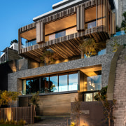 The home was conceived as an arrangement of apartment, architecture, building, estate, facade, home, house, interior design, mixed-use, property, real estate, residential area, sky, tree, black